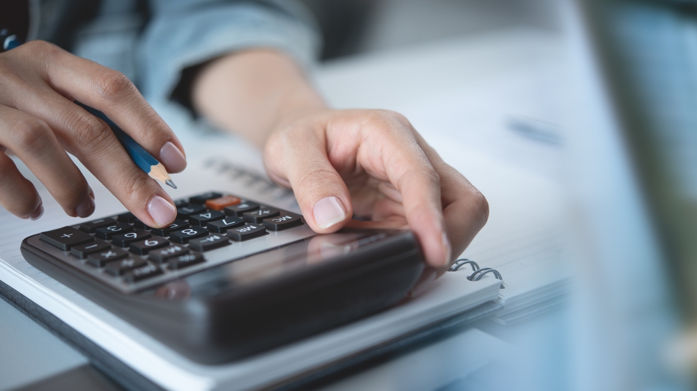 Close,Up,Woman,Hand,Using,Calculator,To,Calculate,Home,Finance